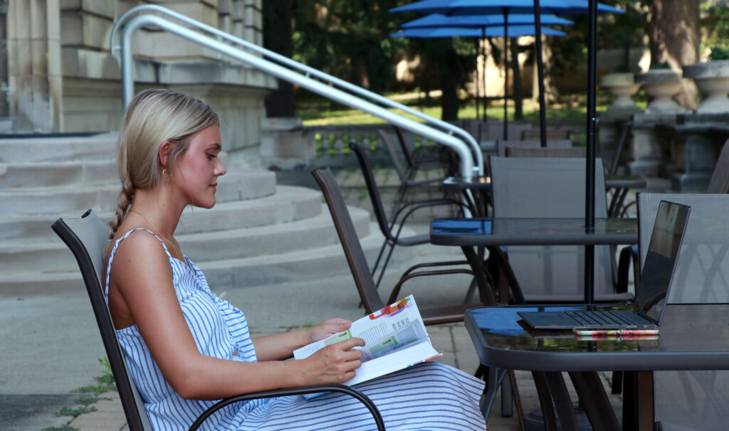 A female student studying outside
