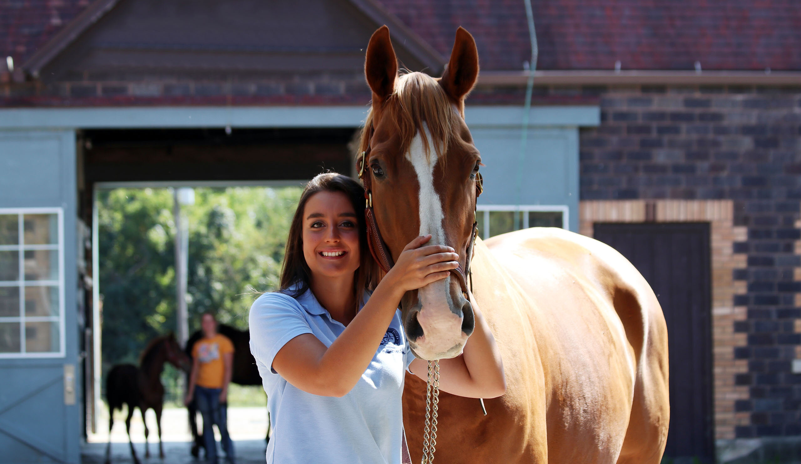 Savannah smiling with a horse