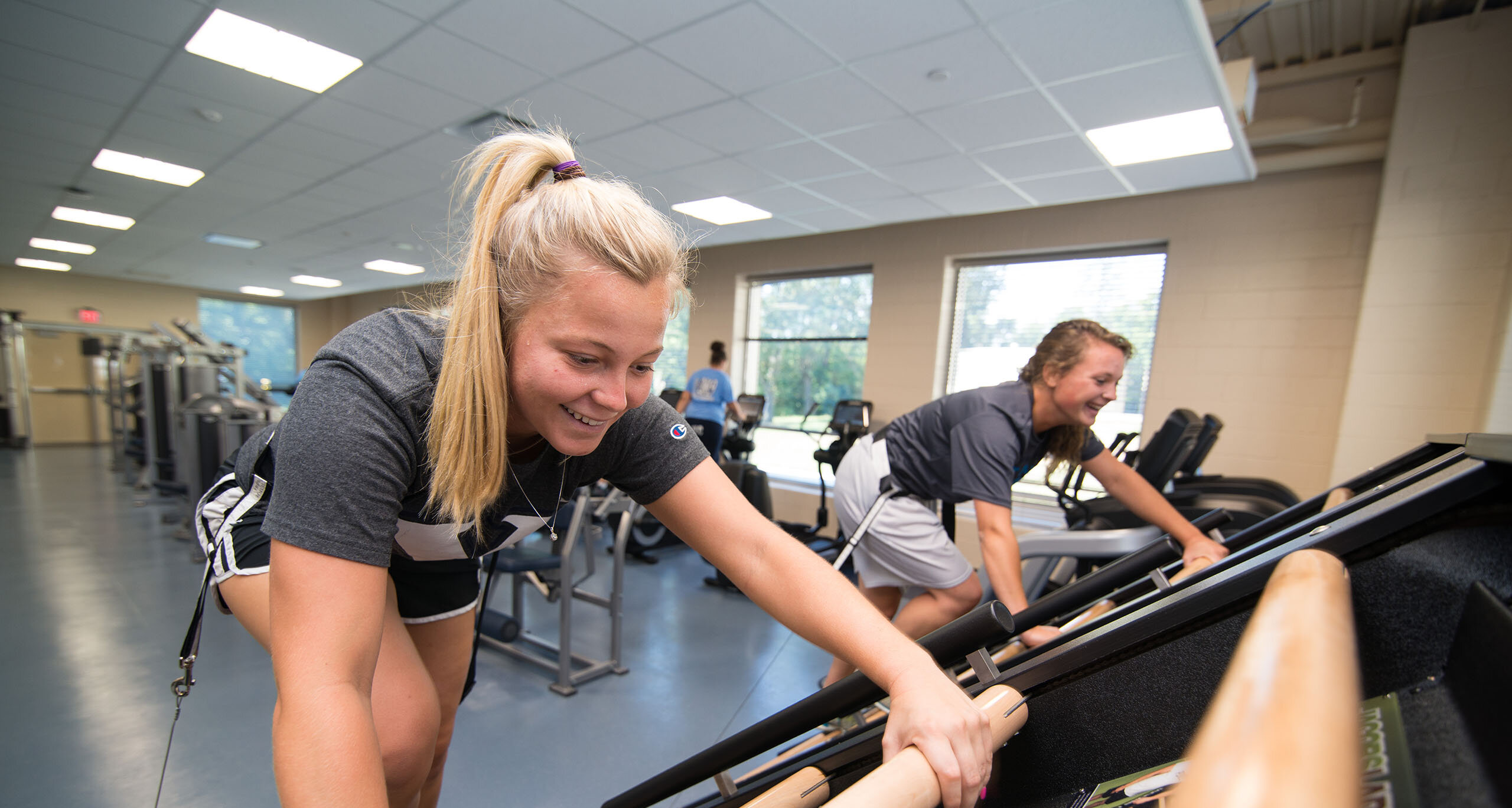 Students using the ladder climber in the gym