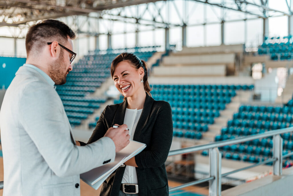 Sport managers conversing in athletics arena