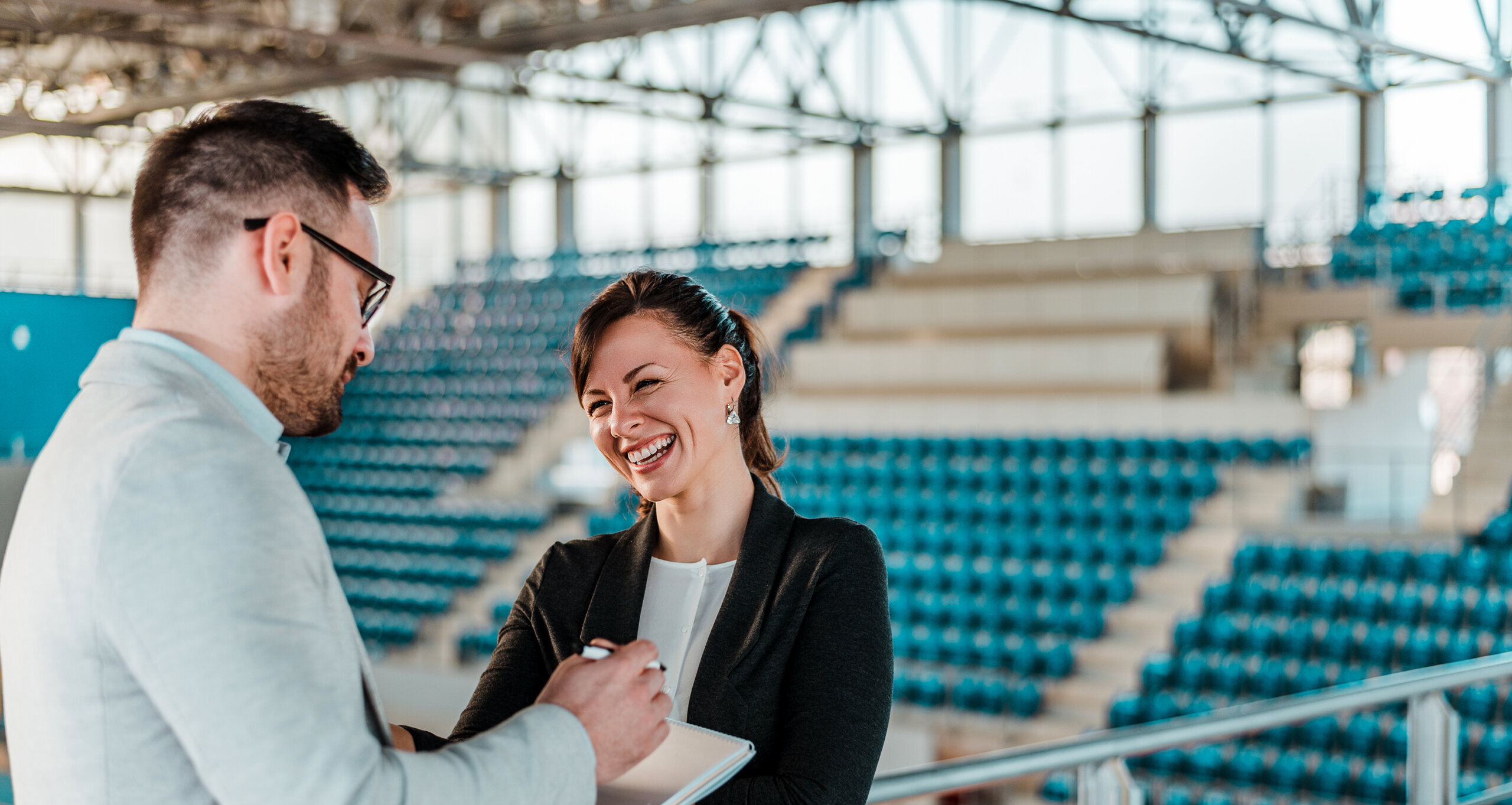 Sport managers conversing in athletics arena