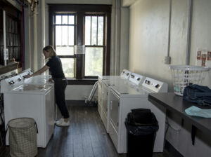 A student using Le Fer's free clothes washers 