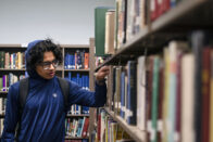 Student browsing books in the library