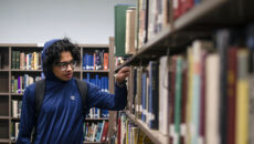 Student browsing books in the library