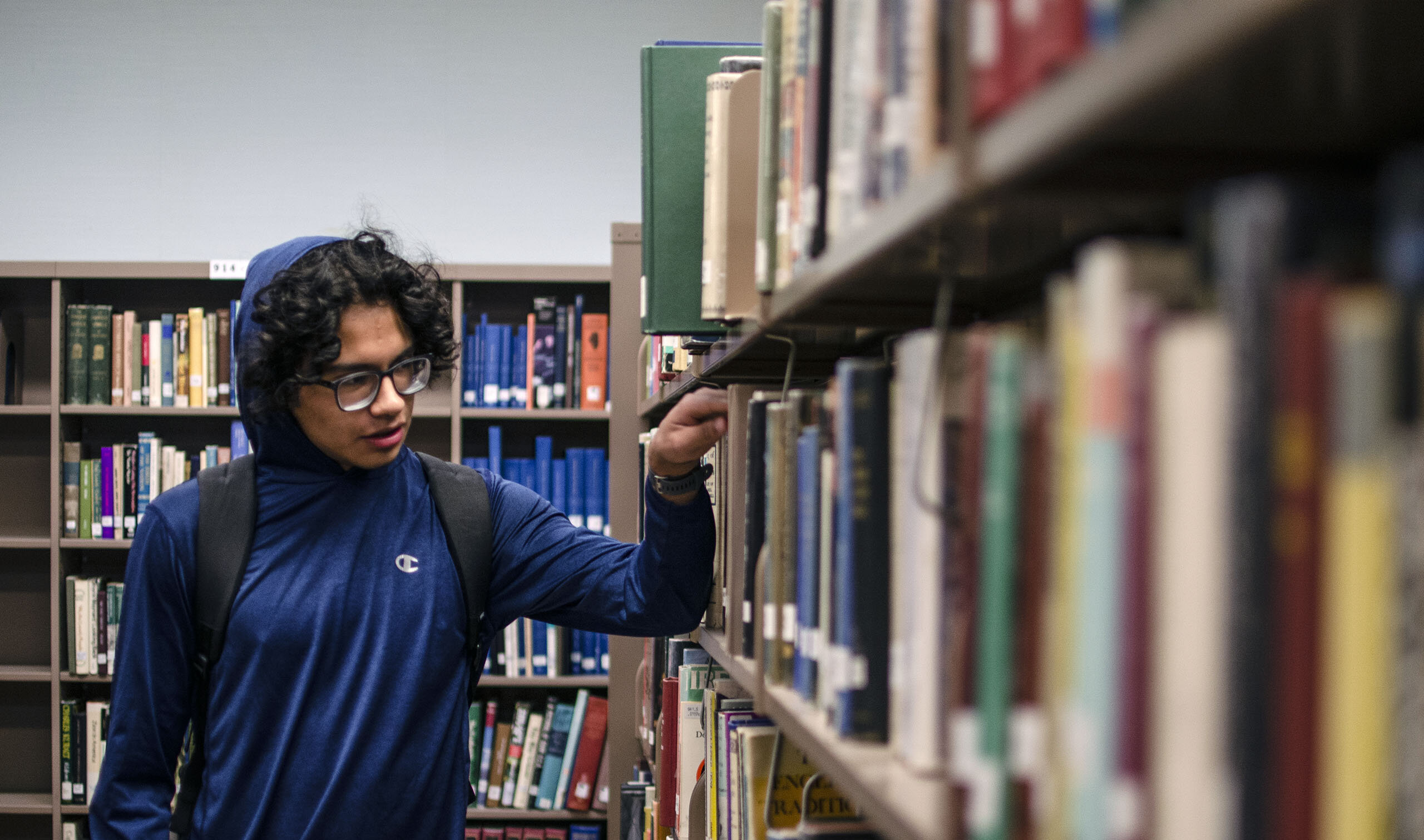 Student browsing books in the library