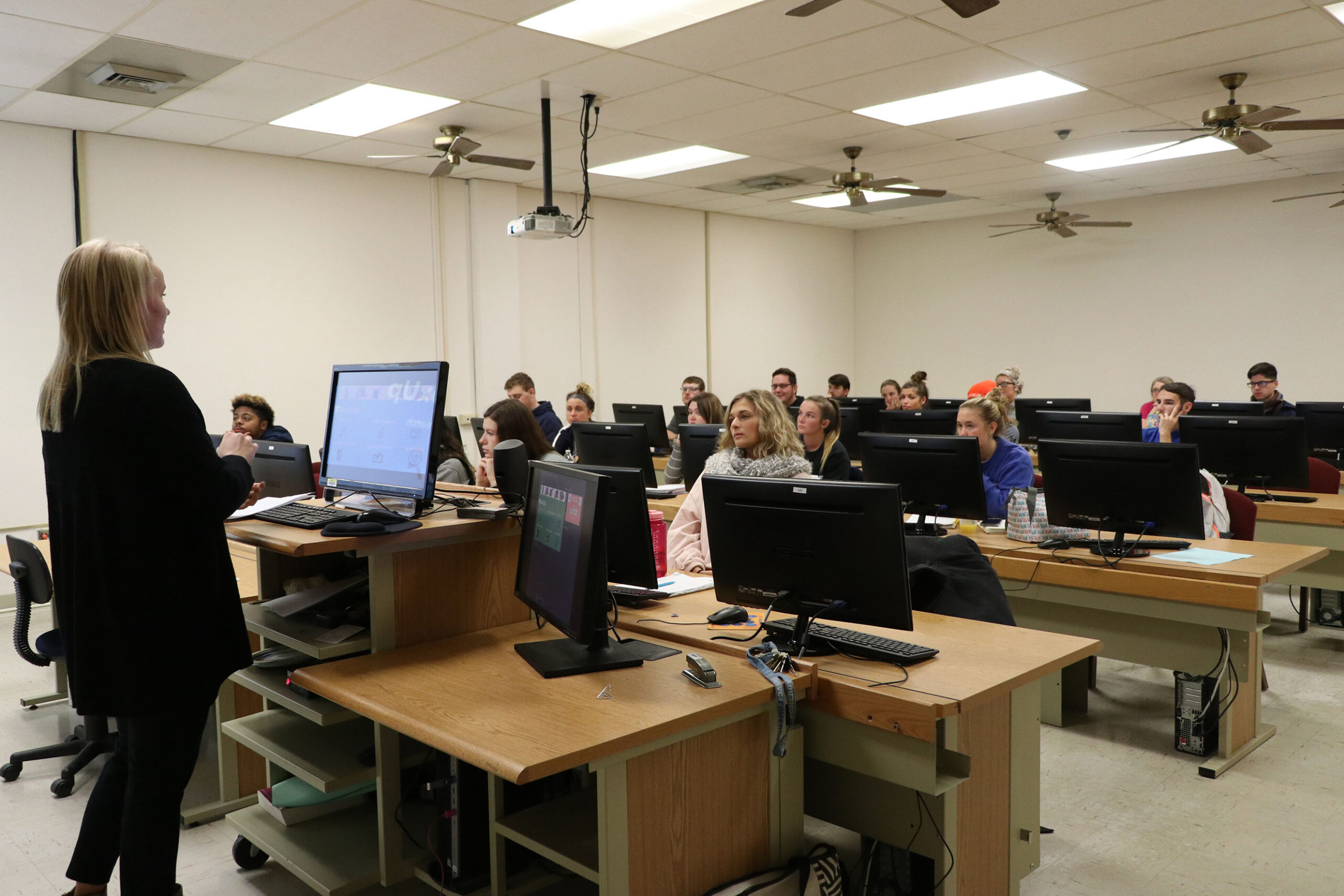 Instructor teaching class of students in computer lab