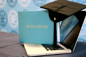SMWC diploma and cap sitting on a laptop