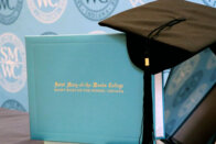 SMWC diploma and cap sitting on a laptop