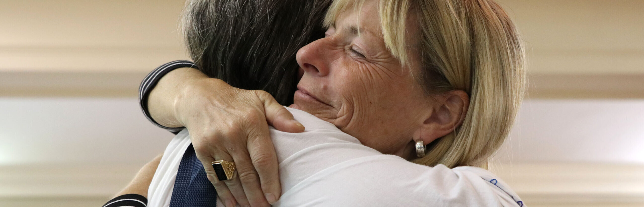 Friends hugging at reunion