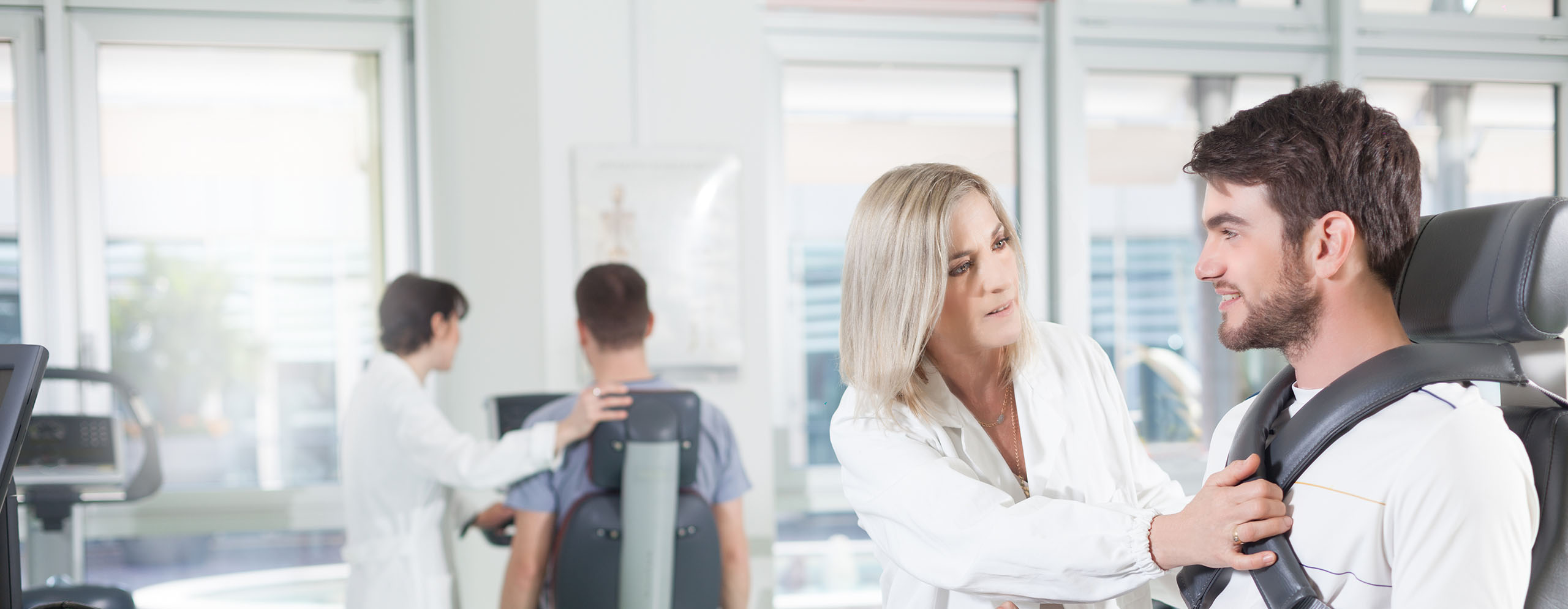 Professional helping a patient in an exercise science clinic