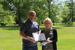 Zach Whitkanack is presented the Outstanding Staff Award by Dottie King