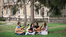 students on the lawn playing music together