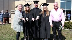 3 siblings and their mom pose with a Ring