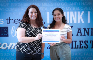 Sharon Boyle, left, presents the Musician of Promise scholarship to Joynelis Caminero Santiago.