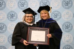 Dottie giving an Alum the distinguished Alumni Award