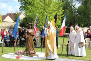 Monsignor Le Saux blessing the sculpture