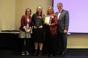 Stattner standing with group at ICI banquest