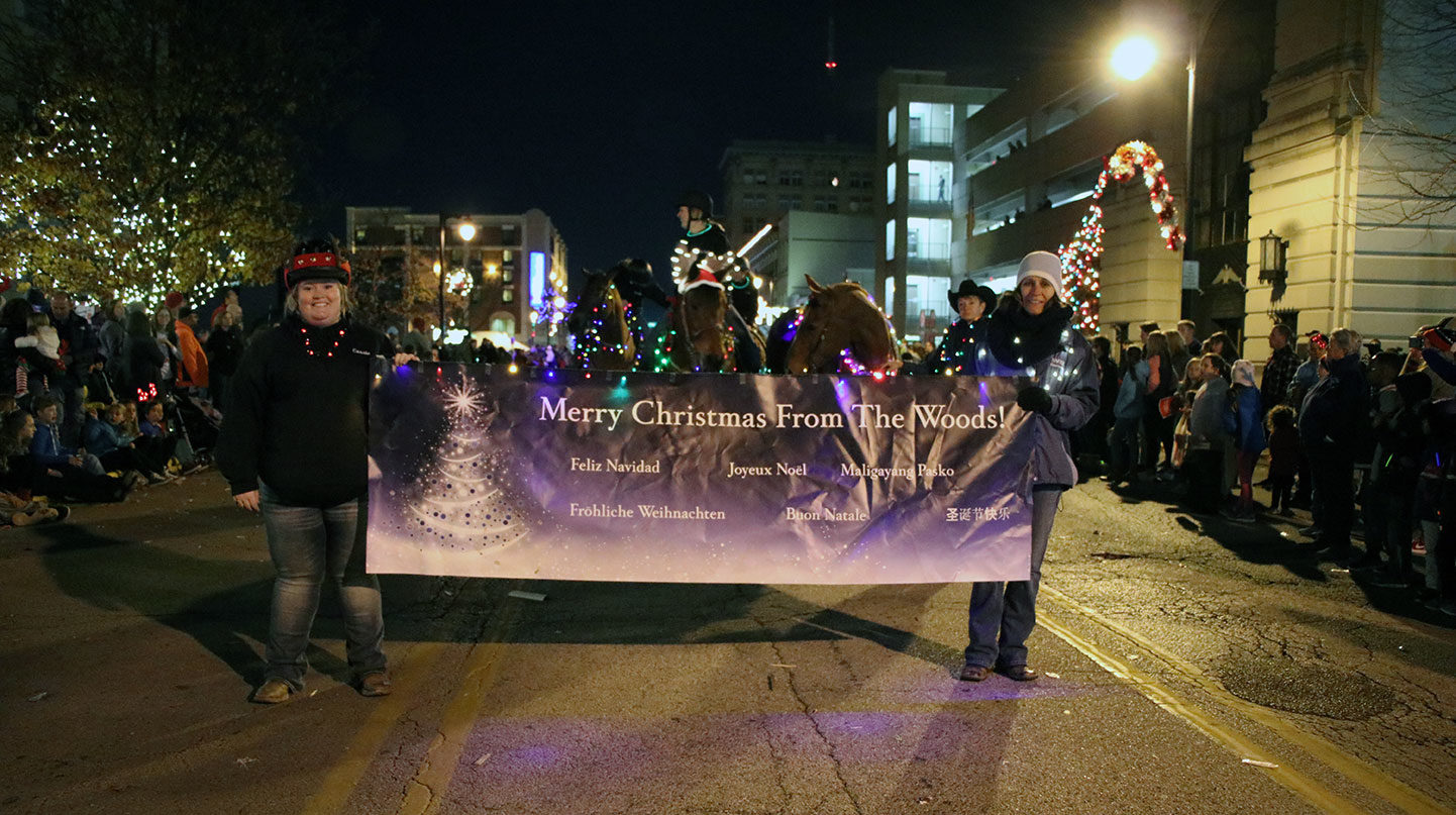 SMWC staff and students holding parade banner