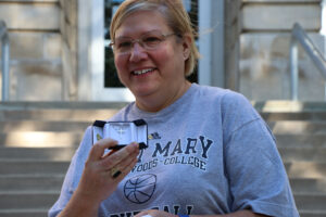 Nancy Payonk holding cross necklace