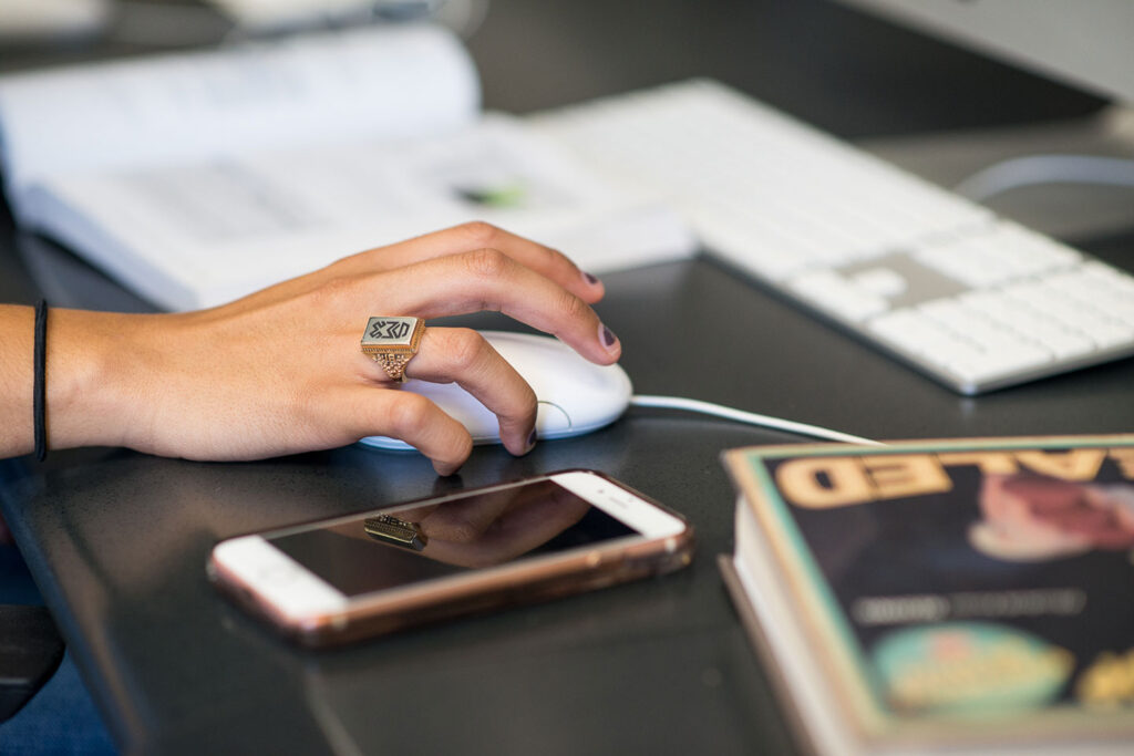 Design student using computer in Mac lab
