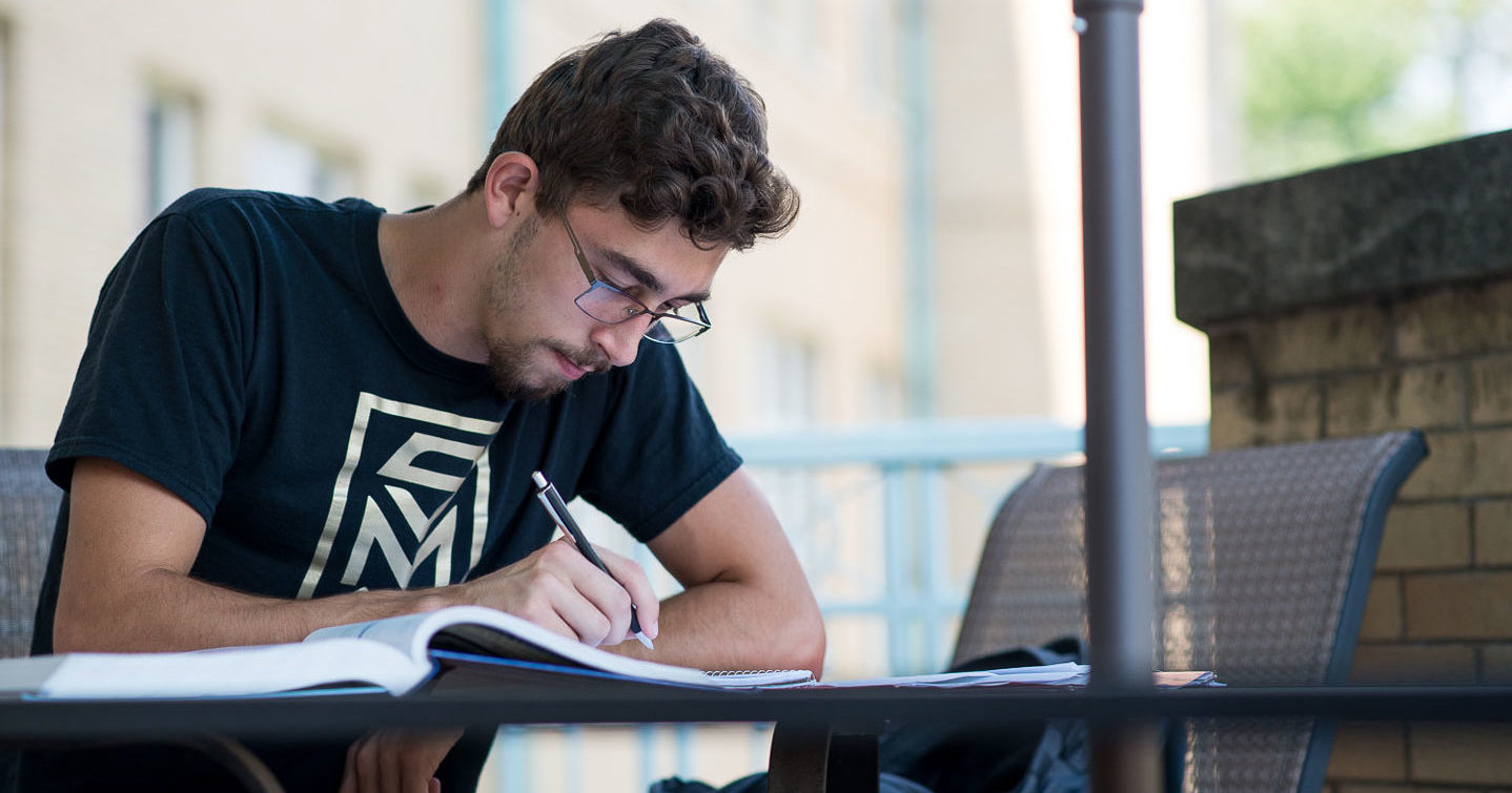 Guy studying outdoors