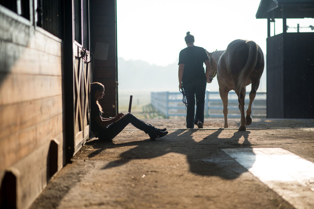 Student sitting in barn studying