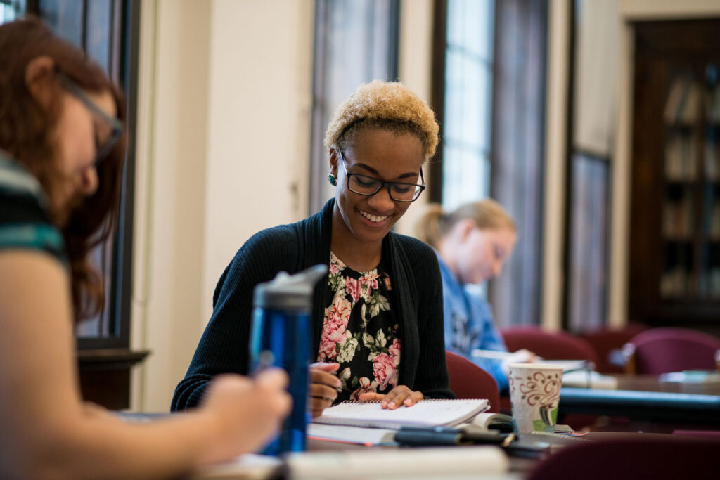 Smiling student participating in writing workshop