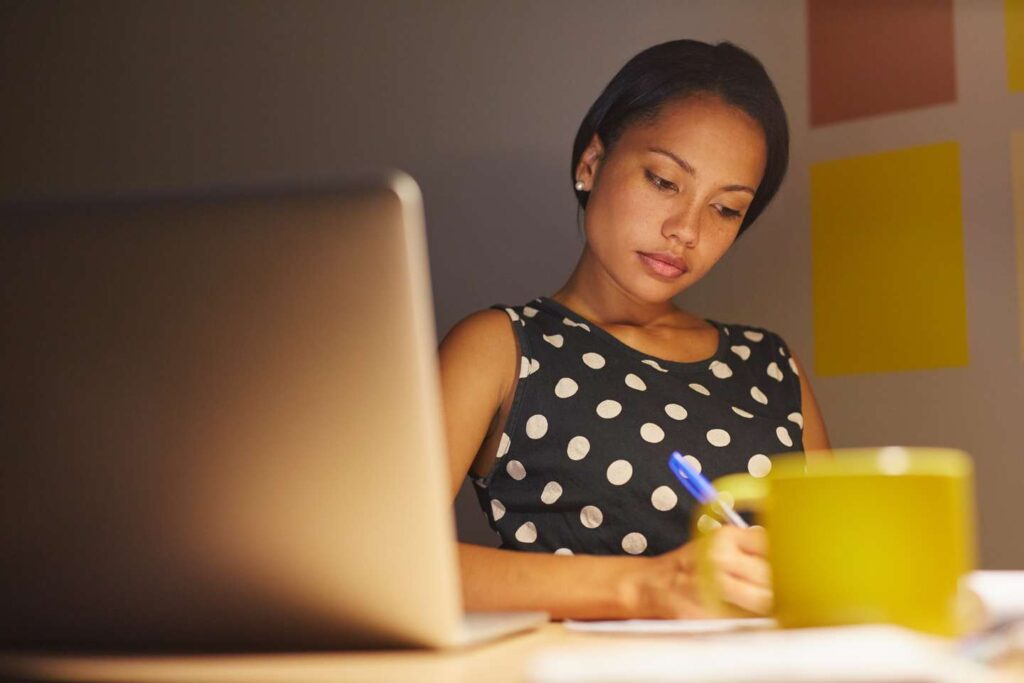 woman at computer black and white pokadotted dress