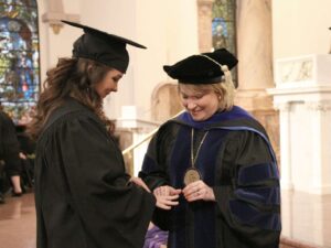 Dottie putting ring on student at Ring Day 2017