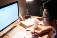 WOL asian guy studying at desk with computer