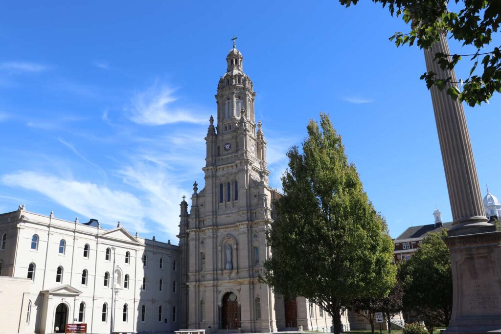 The beautiful church steeple against the blue sky on campus.