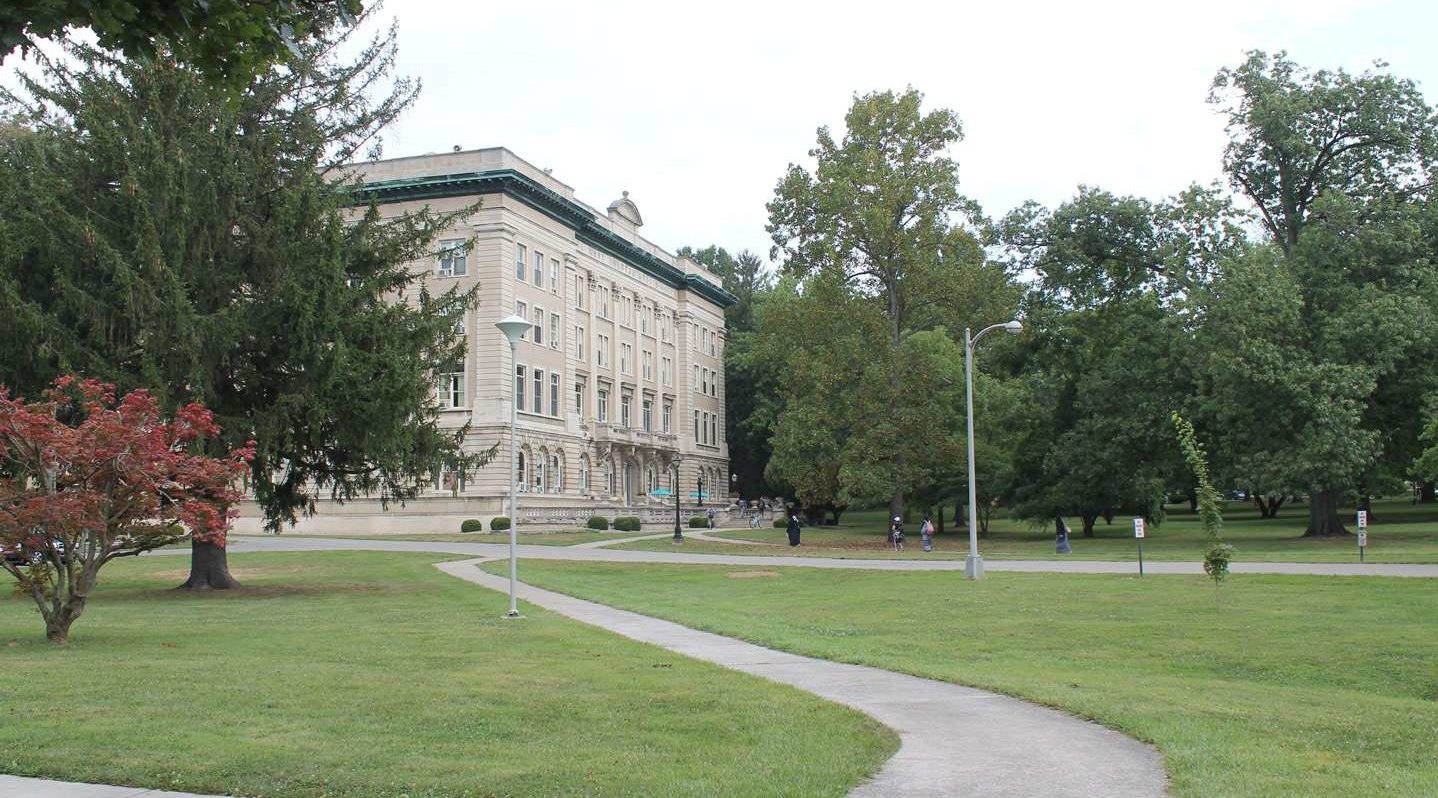 Students walking on the sidewalk up to Guerin Hall.