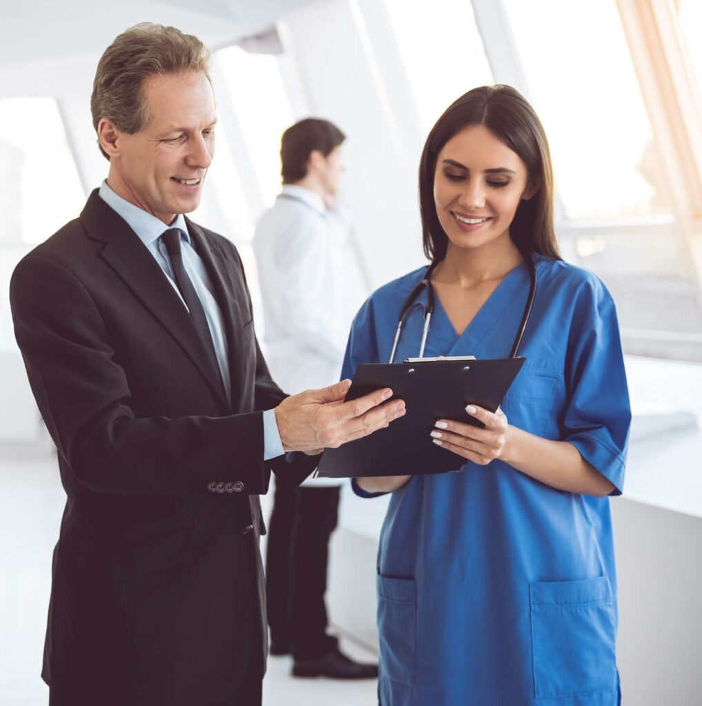 A hospital administrator talks to one of the nurses.