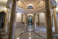 The beautiful Rotunda with large marble columns and a view of the circular arches on the second floor.
