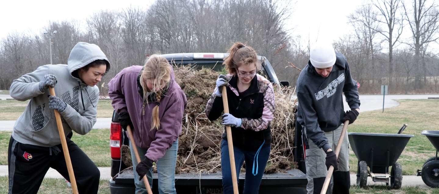 weeding behind Hulman Hall - sustainability