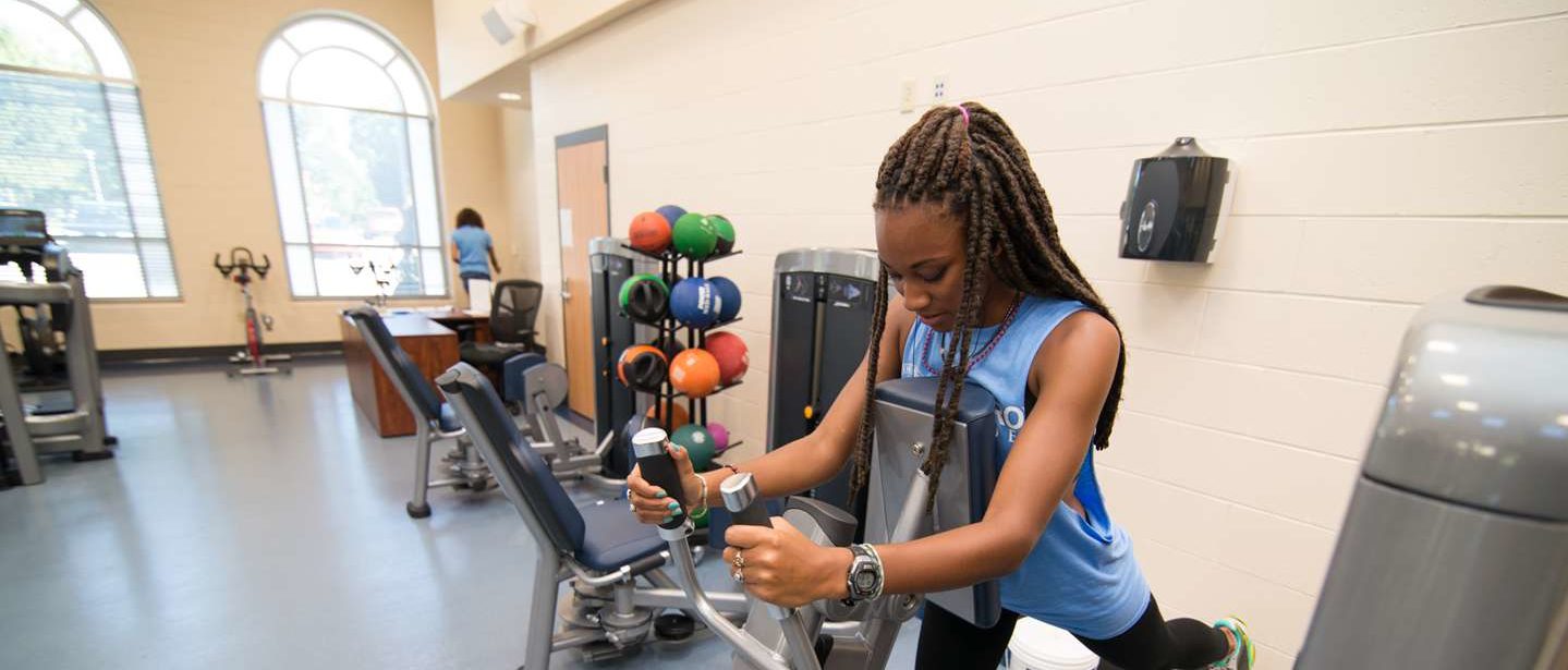 A young woman works out in the fitness center.