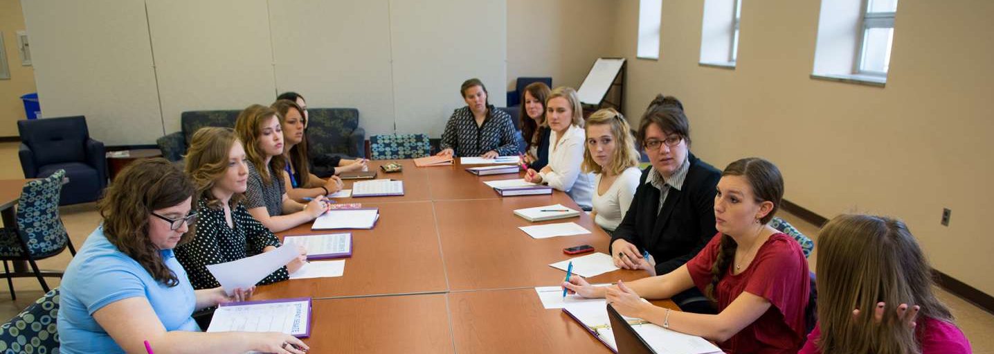 Women students having a meeting in the Woods Student Center.